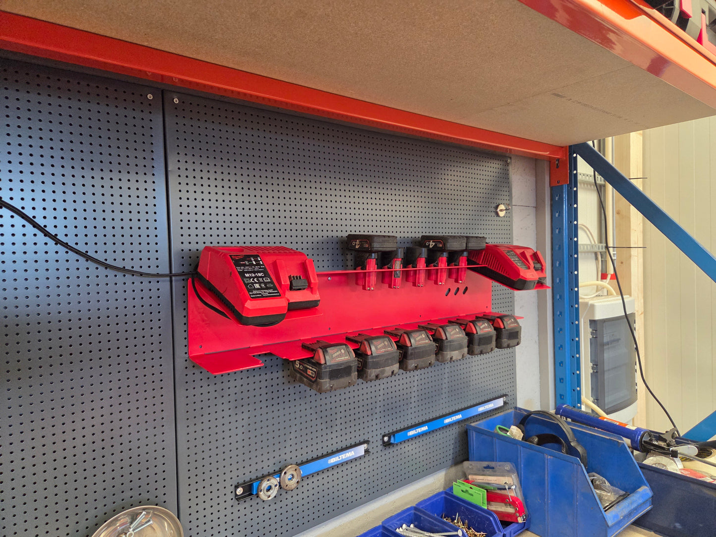 Milwaukee Ladestasjon: 2 ladere, 7 M12-batterier og 5 M18-batterier.